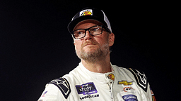 Jul 20, 2024; Hampton, VA, USA; Dale Earnhardt Jr. waits next to his during qualifying for the 16th Annual Hampton Heat at Langley Speedway. Mandatory Credit: Peter Casey-Imagn Images