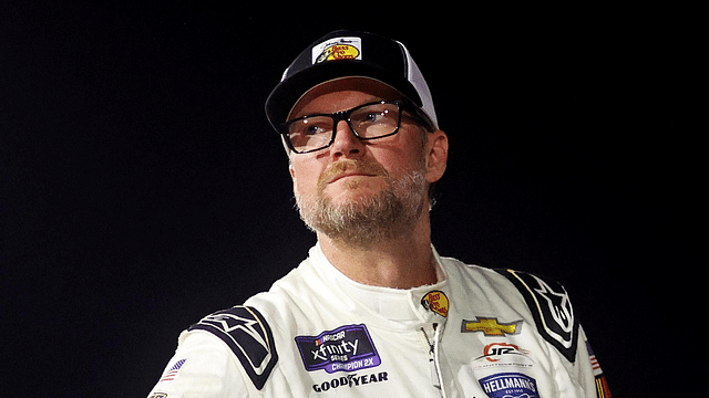 Jul 20, 2024; Hampton, VA, USA; Dale Earnhardt Jr. waits next to his during qualifying for the 16th Annual Hampton Heat at Langley Speedway. Mandatory Credit: Peter Casey-Imagn Images