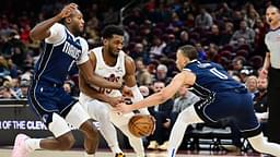 Cleveland Cavaliers guard Donovan Mitchell (45) drives to the basket between Dallas Mavericks forward Olivier-Maxence Prosper (8) and guard Dante Exum (0) during the second half at Rocket Mortgage FieldHouse.