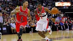 Washington Wizards point guard John Wall (2) dribbles the ball as Chicago Bulls point guard Derrick Rose (1) defends in the first half at Verizon Center.