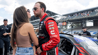 Jul 30, 2022; Speedway, Indiana, USA; NASCAR Xfinity Series driver Chase Briscoe (07) kisses his wife before the Penzoil 150 at the Indianapolis Motor Speedway Road Course. Mandatory Credit: Marc Lebryk-Imagn Images