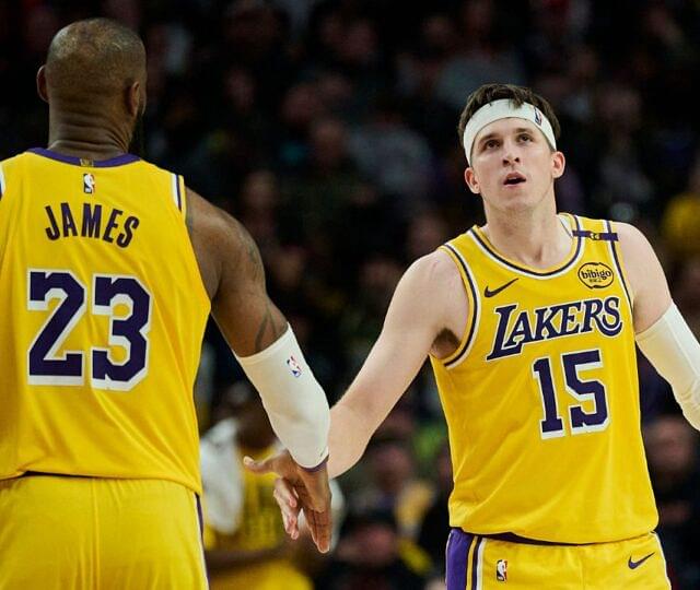 Los Angeles Lakers guard Austin Reaves (15) high fives forward LeBron James (23) during the second half against the Portland Trail Blazers at Moda Center.