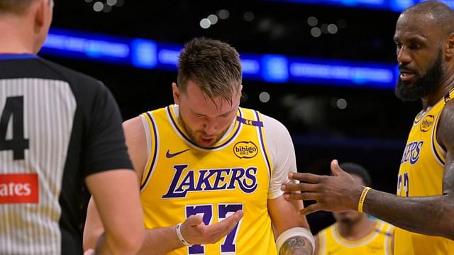 Los Angeles Lakers forward LeBron James (23) checks on guard Luka Doncic (77) after he was hit in the face against the Utah Jazz at Crypto.com Arena.