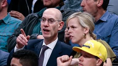 NBA commissioner Adam Silver (L) takes in the game with his wife Maggie Grise (R) in the third quarter of the game between the Denver Nuggets and the Detroit Pistons at the Pepsi Center.