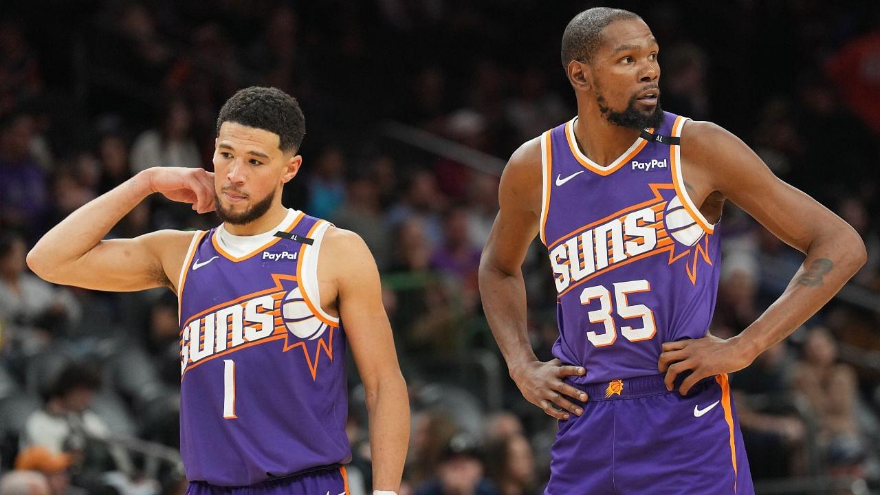 Phoenix Suns guard Devin Booker (1) and Phoenix Suns forward Kevin Durant (35) look on against the Brooklyn Nets during the second half at Footprint Center.