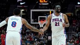 Philadelphia 76ers center Joel Embiid (21) and forward Paul George (8) high five during the second half against the Portland Trail Blazers at Moda Center.