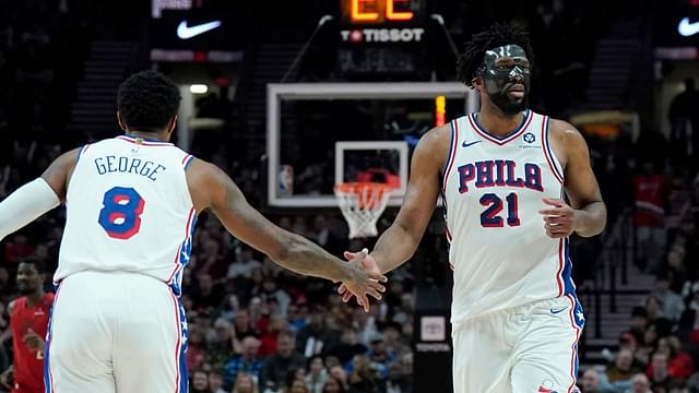 Philadelphia 76ers center Joel Embiid (21) and forward Paul George (8) high five during the second half against the Portland Trail Blazers at Moda Center.