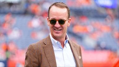 Retired NFL player Peyton Manning stands on the sidelines of Empower Field at Mile High before the game between the Carolina Panthers Denver Broncos.