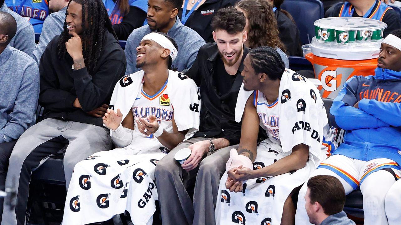 Oklahoma City Thunder guard Cason Wallace (22), guard Shai Gilgeous-Alexander (2), forward Chet Holmgren (7) and forward Jalen Williams (8) watch the game against the Phoenix Suns from the bench during the fourth quarter of a game at Paycom Center.