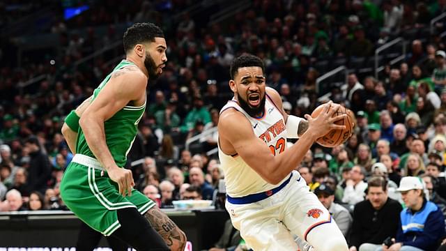 New York Knicks center Karl-Anthony Towns (32) controls the ball while Boston Celtics forward Jayson Tatum (0) defends during the first half at TD Garden.