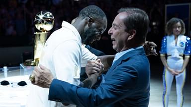 Golden State Warriors forward Draymond Green (23) hugs owner Joe Lacob (right) after receiving his championship ring before the game against the Los Angeles Lakers at Chase Center.