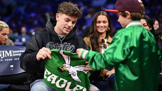 Philadelphia Eagles Cooper DeJean interacts with fans during the game between the Philadelphia 76ers and the Toronto Raptors at Wells Fargo Center.