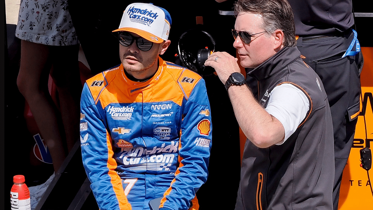 Arrow McLaren/Rick Hendrick driver Kyle Larson (17) sits on the pit wall as he talks with Jeff Gordon on Sunday, May 19, 2024, during Top 12 qualifying for the 108th running of the Indianapolis 500 at Indianapolis Motor Speedway.