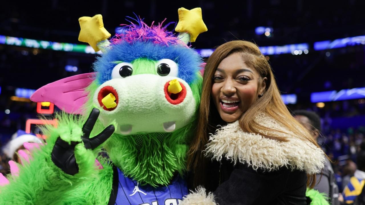 Dec 23, 2024; Orlando, Florida, USA; Chicago Sky forward Angel Reese hugs Orlando Magic Stuff during an NBA game against the Boston Celtics at Kia Center.