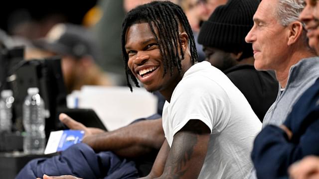 Jan 22, 2025; Dallas, Texas, USA; 2024 Heisman Trophy winner Travis Hunter Jr. laughs during the second half of the game between the Dallas Mavericks and the Minnesota Timberwolves at the American Airlines Center.