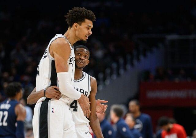 San Antonio Spurs center Victor Wembanyama (1) and guard De'Aaron Fox (4) react during the second quarter against the Washington Wizards at Capital One Arena