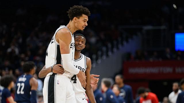 San Antonio Spurs center Victor Wembanyama (1) and guard De'Aaron Fox (4) react during the second quarter against the Washington Wizards at Capital One Arena