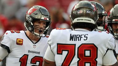 Tampa Bay Buccaneers quarterback Tom Brady (12) huddles up with offensive tackle Tristan Wirfs (78) against the Carolina Panthers prior to the game at Raymond James Stadium.