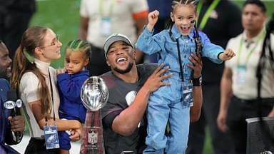 Philadelphia Eagles running back Saquon Barkley (26) talks to the media with his daughter, Jada, after defeating the Kansas City Chiefs in Super Bowl LIX at Caesars Superdome.