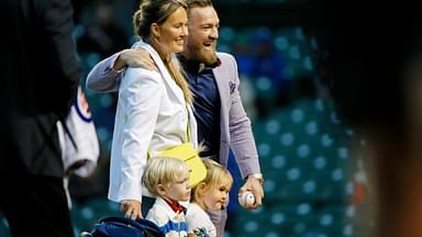 MMA fighter Conor McGregor poses for a photo with his fiance Dee Devlin, his son Conor Jack Jr., and daughter Croia after throwing out a first pitch before the game between the Chicago Cubs and the Minnesota Twins at Wrigley Field.