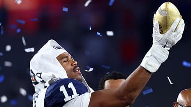 Penn State Nittany Lions defensive end Abdul Carter (11) reacts with the trophy after the game against the Boise State Broncos in the Fiesta Bowl at State Farm Stadium.