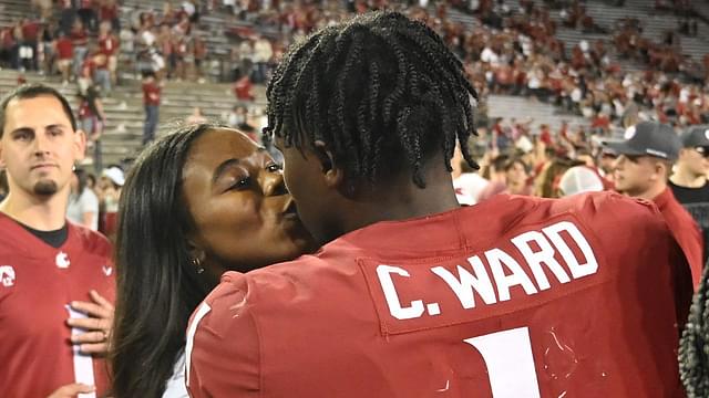 Washington State Cougars quarterback Cameron Ward (1) gets a kiss from his girlfriend Nailah London after a game against the Wisconsin Badgers at Gesa Field at Martin Stadium. Washington State won 31-22.