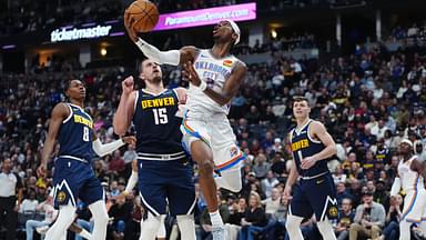 Oklahoma City Thunder guard Shai Gilgeous-Alexander (2) shoots the ball past Denver Nuggets center Nikola Jokic (15) in the second quarter at Ball Arena.