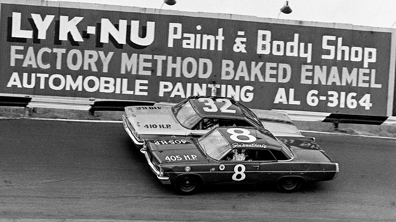 Drivers Joe Weatherly (8) and Tiny Lund (32) battle for position in the Nashville 400 at the Fairgrounds Speedway Aug. 4, 1963. Weatherly went on to place third, while Lund was 16th after getting knocked out with a fiery crash in the rain-shortened NASCAR late model race before 12,875 fans. Auto Racing In 1963