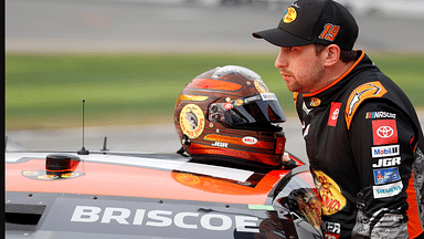 Feb 16, 2025; Daytona Beach, Florida, USA; NASCAR Cup Series driver Chase Briscoe (19) prepares to get in the car after a rain delay for the Daytona 500 at Daytona International Speedway. Mandatory Credit: Peter Casey-Imagn Images