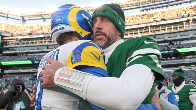 Dec 22, 2024; East Rutherford, New Jersey, USA; Los Angeles Rams quarterback Matthew Stafford (9) hits New York Jets quarterback Aaron Rodgers (8) after the game at MetLife Stadium.