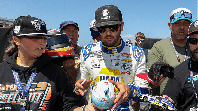 Aug 19, 2023; Watkins Glen, New York, USA; NASCAR Cup Series driver Chase Elliott signs autographs for fans during practice and qualifying for the Go Bowling at The Glen at Watkins Glen International. Mandatory Credit: Matthew O'Haren-Imagn Images