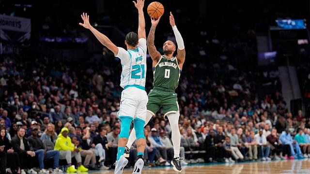 Milwaukee Bucks guard Damian Lillard (0) shoots the jumper over Charlotte Hornets guard KJ Simpson (25) during the second quarter at Spectrum Center.