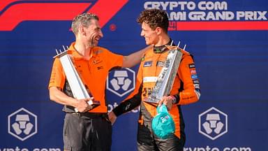 McLaren team principal Andrea Stella and McLaren driver Lando Norris of the United Kingdom hold their trophies as they celebrate on the podium