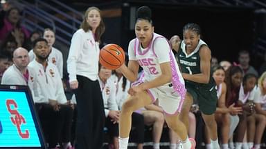 Southern California Trojans guard JuJu Watkins (12) dribbles the ball against Michigan State Spartans guard Jaddan Simmons (1) in the first half at Galen Center