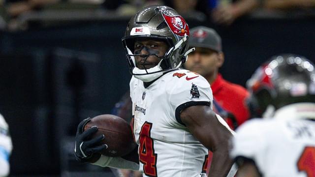 Oct 13, 2024; New Orleans, Louisiana, USA; Tampa Bay Buccaneers wide receiver Chris Godwin (14) looks back at wide receiver Sterling Shepard (17) as he runs in for a touchdown against the New Orleans Saints during the second half at Caesars Superdome.