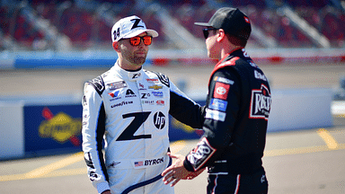 Mar 8, 2025; Avondale, AZ, USA; NASCAR Cup Series driver William Byron (24) meets with driver Christopher Bell (20) during qualifying for the Shrines Children’s 500 at Phoenix Raceway. Mandatory Credit: Gary A. Vasquez-Imagn Images