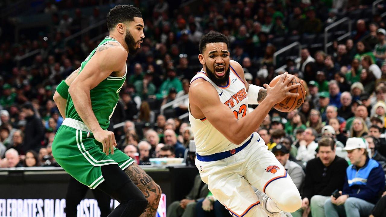 New York Knicks center Karl-Anthony Towns (32) controls the ball while Boston Celtics forward Jayson Tatum (0) defends during the first half at TD Garden.