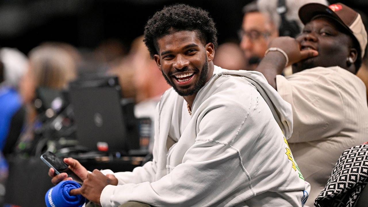 Colorado Buffaloes quarterback Shedeur Sanders laughs as he watches the game between the Dallas Mavericks and the Denver Nuggets during the second half at the American Airlines Center.