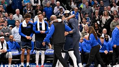 Dallas Mavericks guard Kyrie Irving (11) is helped off the court by forward Anthony Davis (3) during the second quarter against the Sacramento Kings at the American Airlines Center.