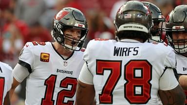 Tampa Bay Buccaneers quarterback Tom Brady (12) huddles up with offensive tackle Tristan Wirfs (78) against the Carolina Panthers prior to the game at Raymond James Stadium.