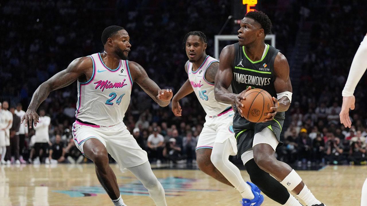 Minnesota Timberwolves guard Anthony Edwards (5) looks for a passing lane as Miami Heat forward Haywood Highsmith (24) and guard Davion Mitchell (45) defend during the second half at Kaseya Center.