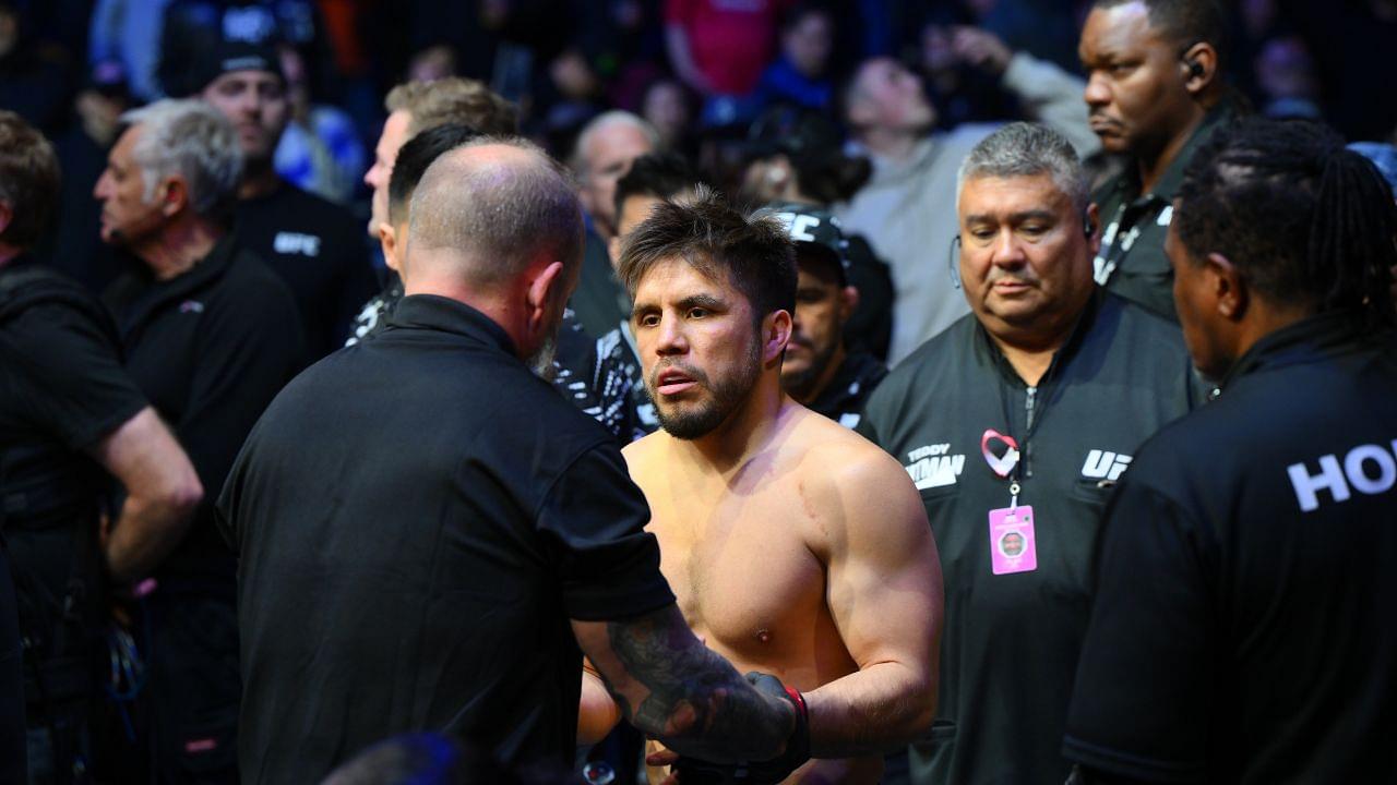 Henry Cejudo (red gloves) is introduced prior to fighting Song Yadong (blue gloves) in the bantamweight bout during UFC Fight Night at Climate Pledge Arena.