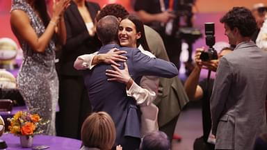 Caitlin Clark embraces her father Brent Clark after she is selected with the number one overall pick to the Indiana Fever in the 2024 WNBA Draft at Brooklyn Academy of Music.