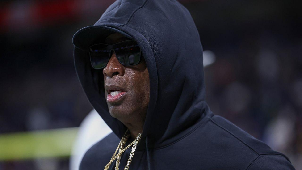 Colorado Buffaloes head coach Deion Sanders jogs on the field before the game against the Brigham Young Cougars at Alamodome.