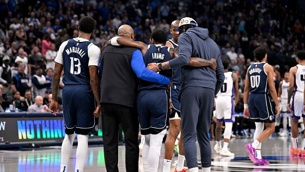 Dallas Mavericks guard Kyrie Irving (11) is helped off the court by forward Naji Marshall (13) and forward Anthony Davis (3) during the second quarter against the Sacramento Kings at the American Airlines Center.