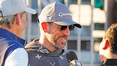 FeJets quarterback Aaron Rodgers talks with the press on the first tee box during the Phoenix Open Annexus Pro-Am at TPC Scottsdale.