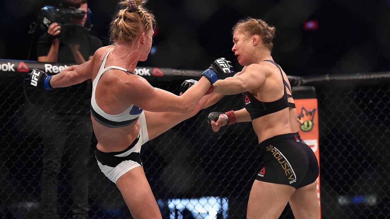 Ronda Rousey (red gloves) competes against Holly Holm (blue gloves) during UFC 193 at Etihad Stadium.