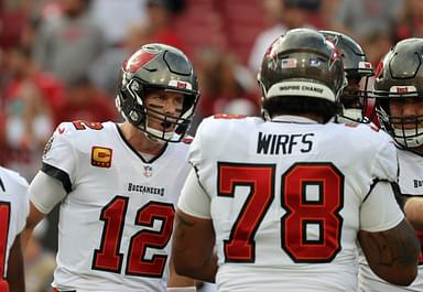 Tampa Bay Buccaneers quarterback Tom Brady (12) huddles up with offensive tackle Tristan Wirfs (78) against the Carolina Panthers prior to the game at Raymond James Stadium.