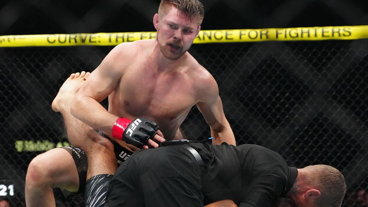 ; Bryce Mitchell (red gloves) reacts to defeating Kron Gracie (blues gloves) at T-Mobile Arena.