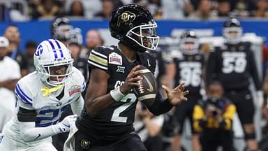 Dec 28, 2024; San Antonio, TX, USA; Colorado Buffaloes quarterback Shedeur Sanders (2) runs with the ball as Brigham Young Cougars cornerback Evan Johnson (21) attempts to make a tackle during the third quarter at Alamodome.